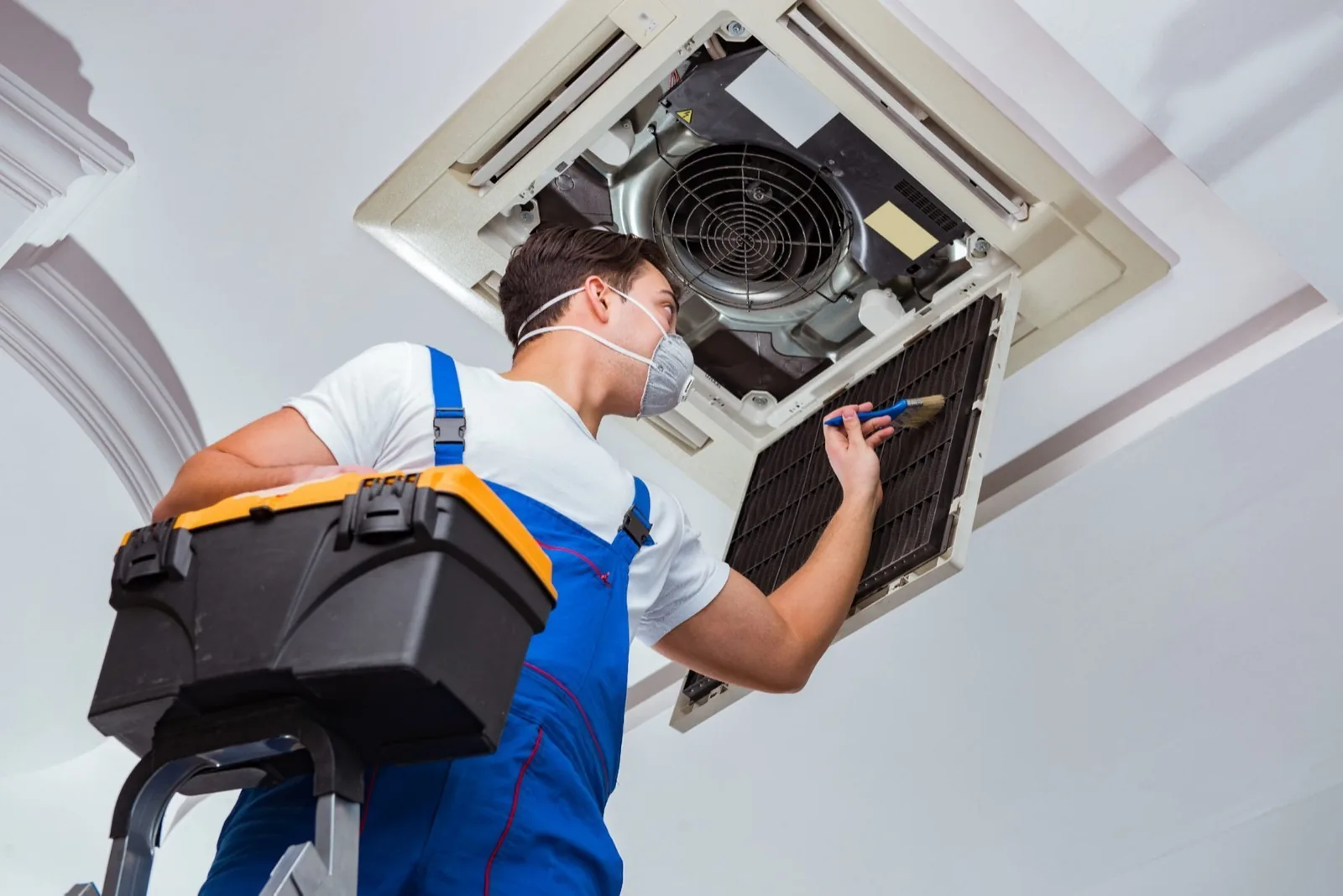 Representative image of an HVAC professional inspecting a residential ceiling system