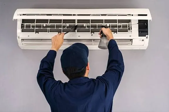 Representative image of routine cleaning on a residential air conditioning unit