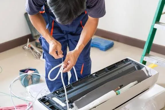 Representative image of wiring and control work on a residential cooling unit